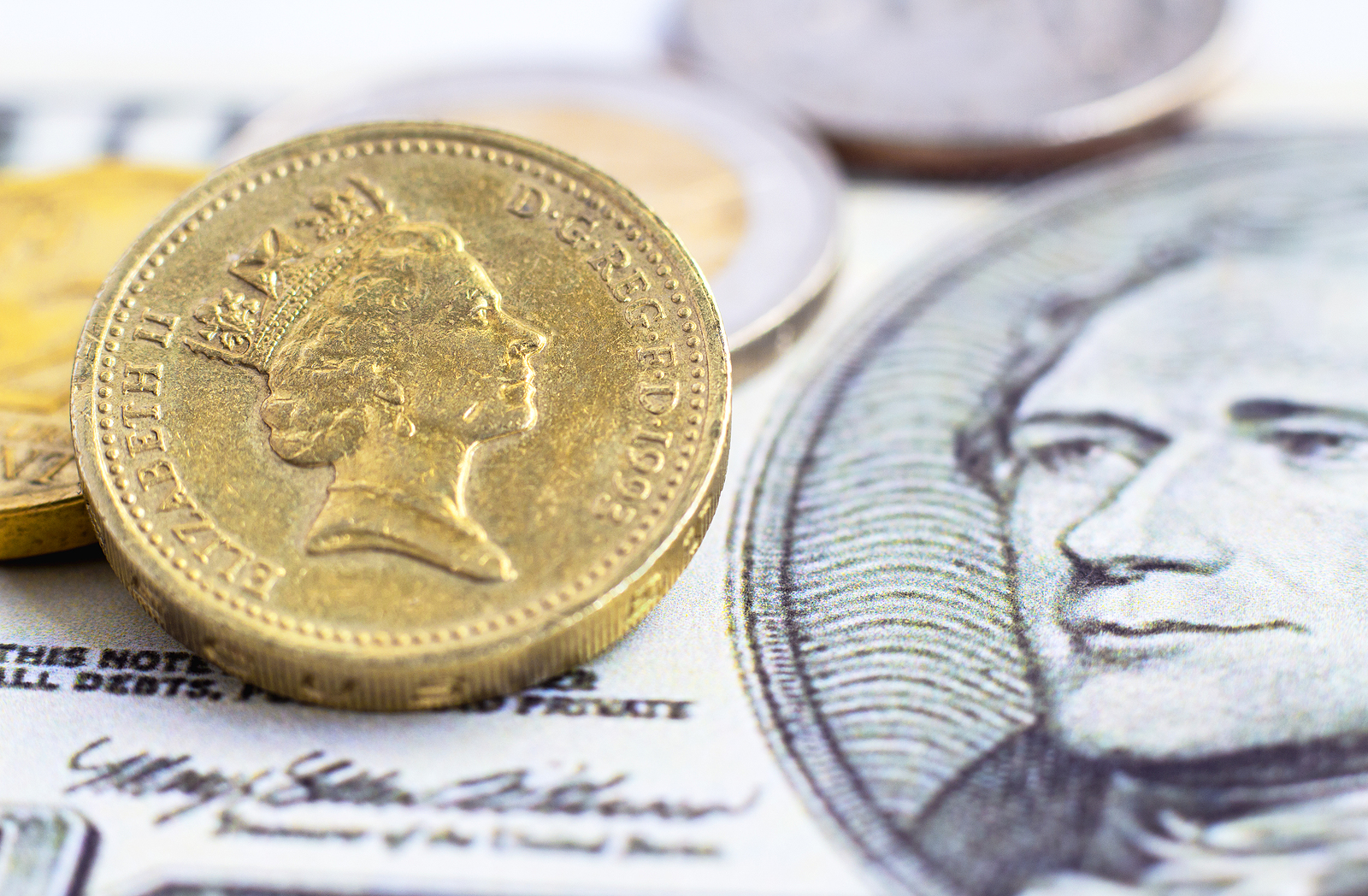 British one pound coin versus us dollar banknote.